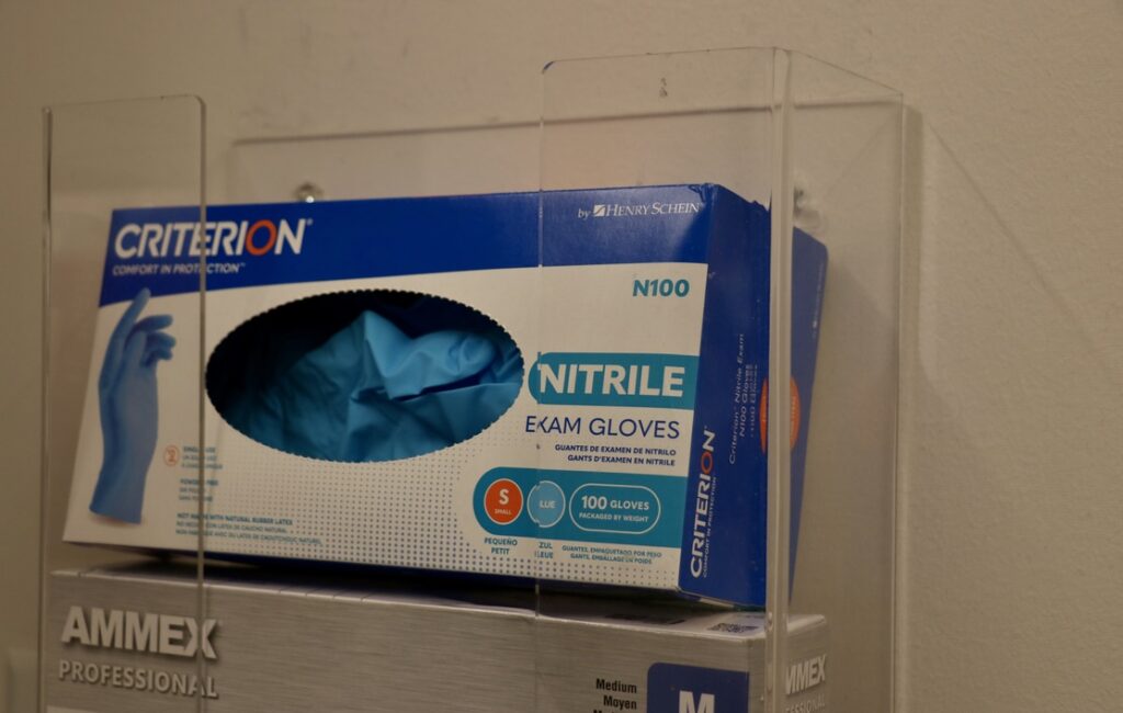 Exam gloves in a health clinic. (Photo by Charlotte Rene Woods/Virginia Mercury)