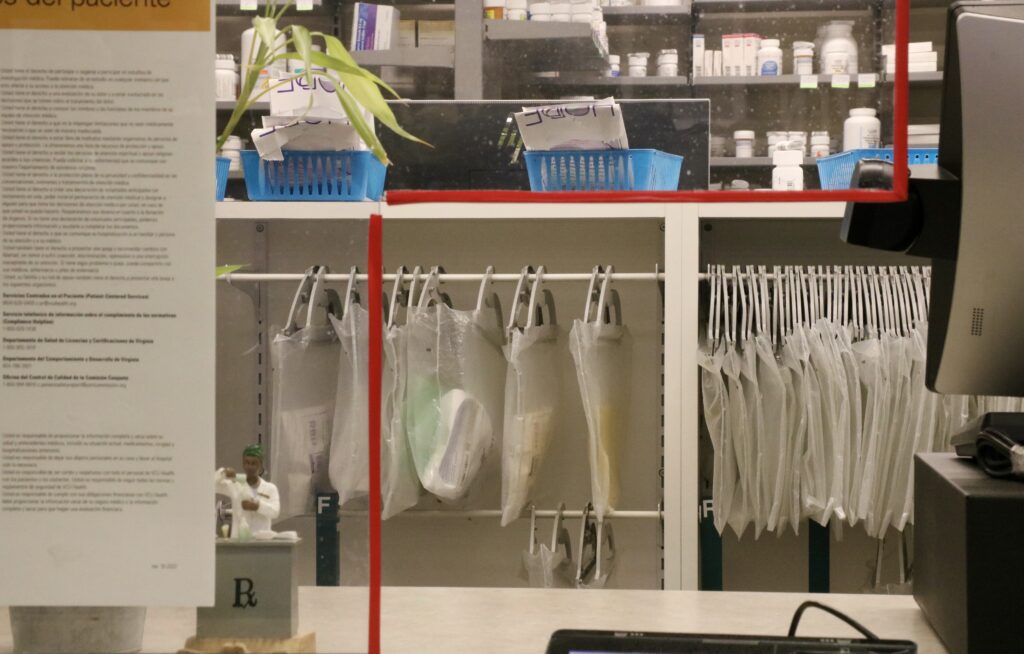 A service window at a pharmacy. (Photo by Charlotte Rene Woods/Virginia Mercury)