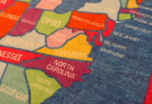 Va. education department says failed proposal to delay cut scores stemmed from legislative mandates A carpet designed with Virginia and the rest of the United States lies inside a classroom. (Photo by Nathaniel Cline/Virginia Mercury)