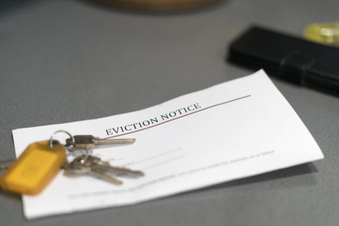House keys sitting on an eviction notice received in the mail. (Photo by Getty Images)