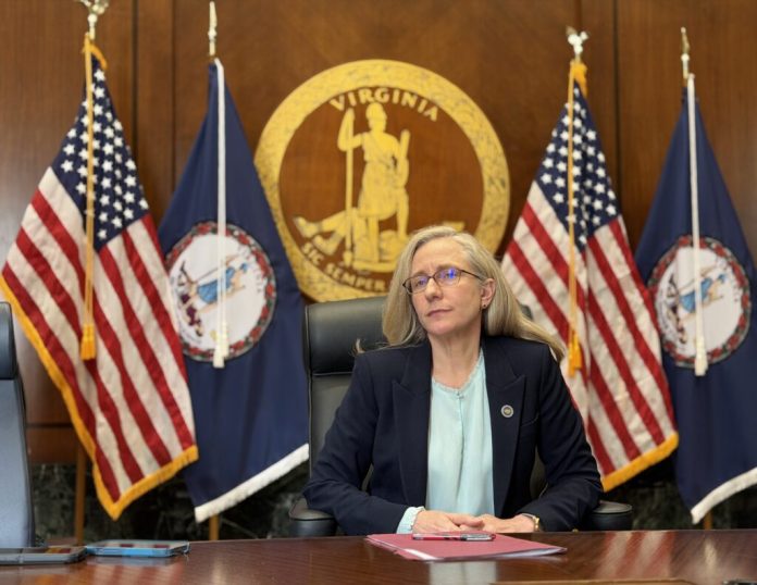 Virginia Gov. Abigail Spanberger speaks with reporters last month in the cabinet room of the Patrick Henry Building in Richmond in July. On Thursday she announced that she will formally intervene in the State Corporation Commission’s review of NextEra Energy’s proposed $67 billion acquisition of Dominion Energy. (Photo by Markus Schmidt/Virginia Mercury)
