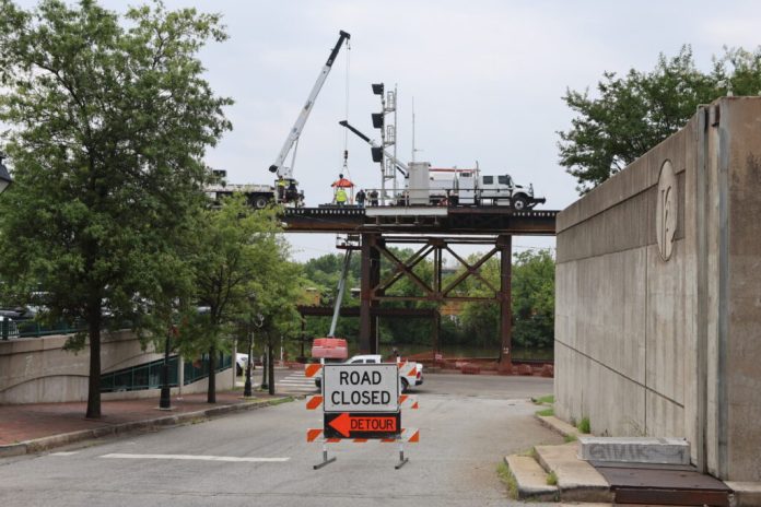 CSX Transportation is working to repair the damage near the intersection of Dock and 20th Streets in Richmond that contributed to three train cars derailing from a 200-car train and crashing into the Riverfront Canal on July 3, 2026. (Photo by Nathaniel Cline/Virginia Mercury)